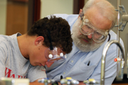 Student with professor in lab.