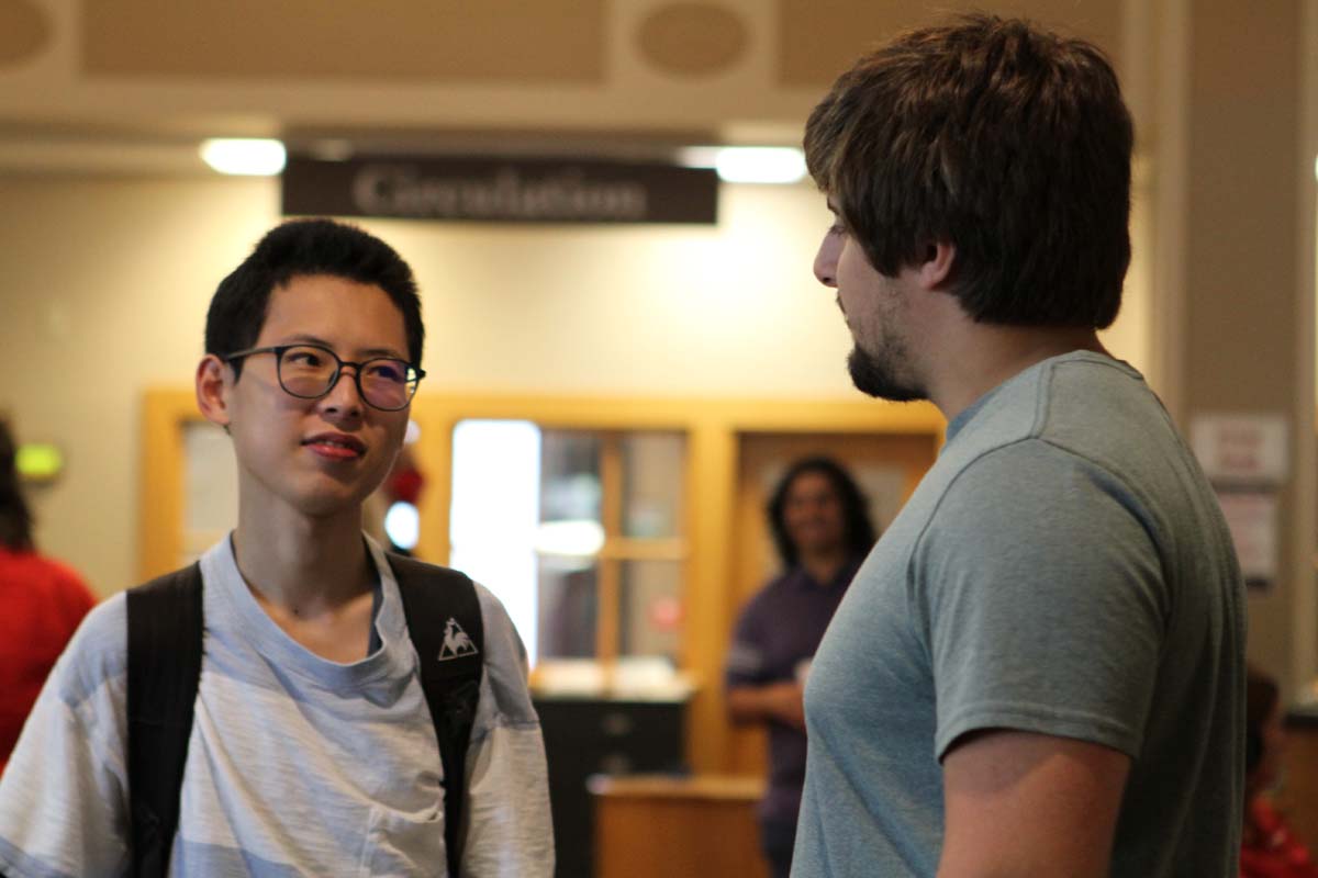 Io Maeda ’24 (left) chats with another Wabash student during WLAIP’s listening party in 2021.