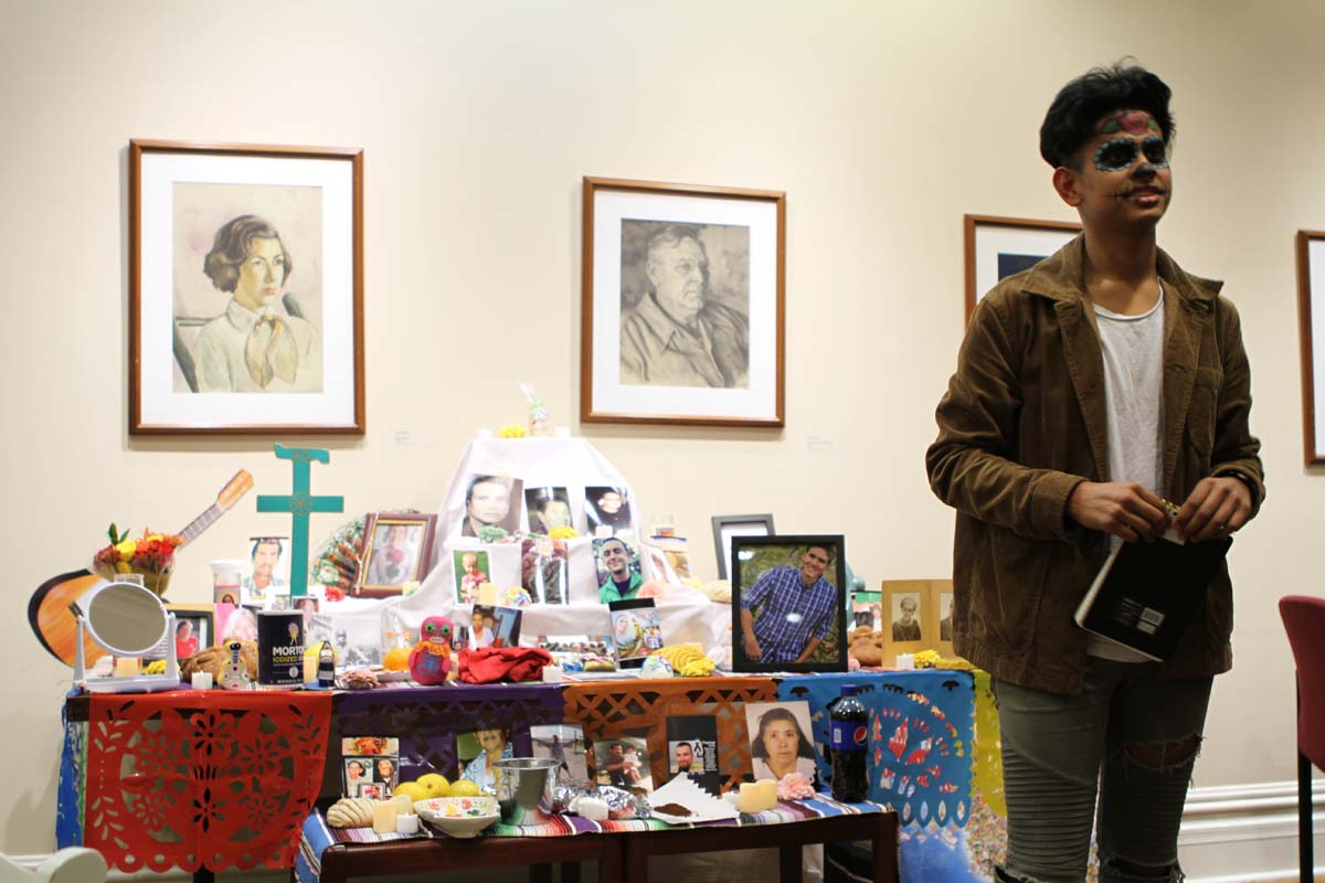 Jonathan Silva-Melendez ’24 explains the tradition of ofrendas during during Día de Muertos, building altars that contain photos and memorabilia of departed loved ones.