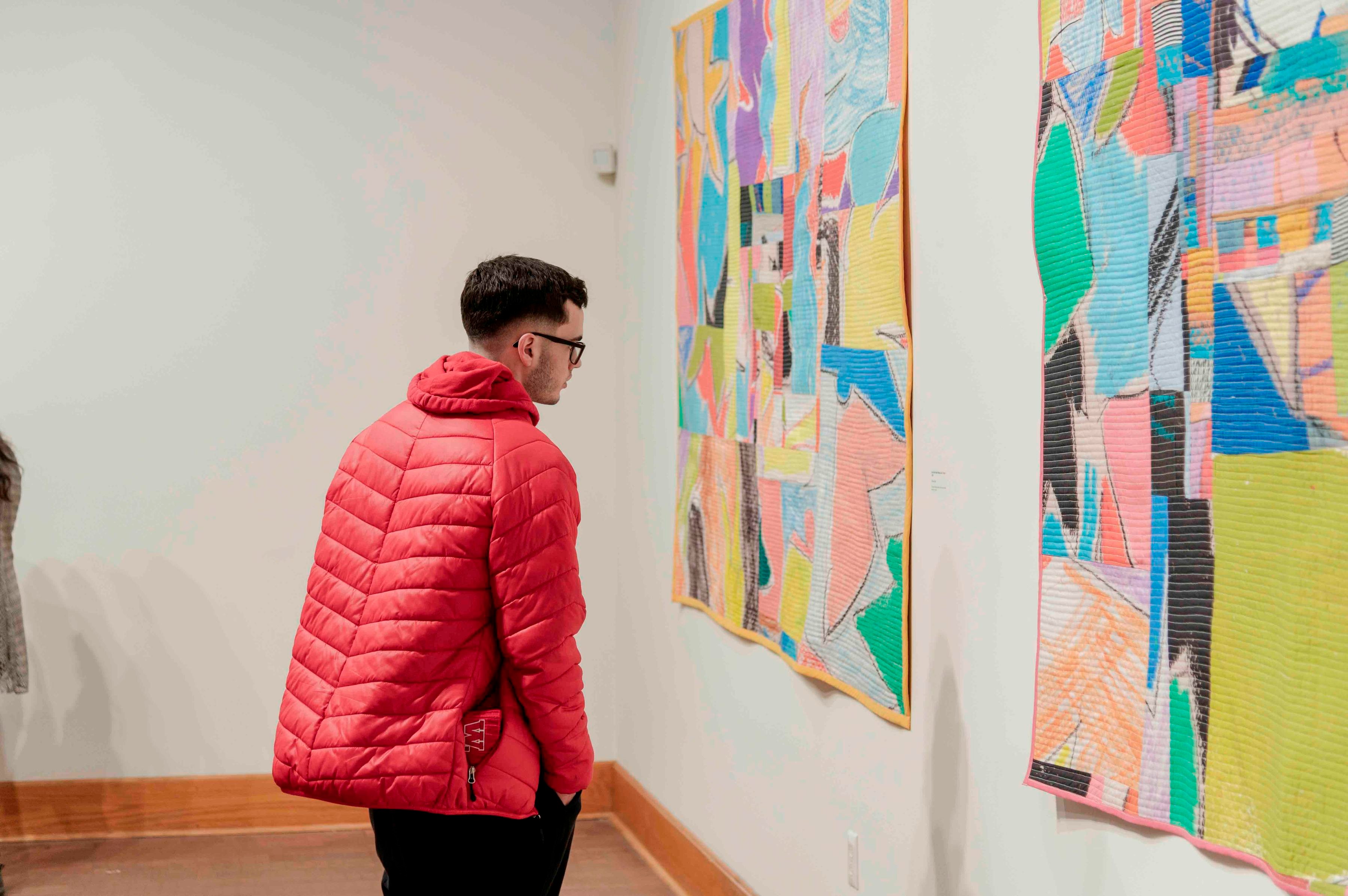 A crowd enjoys the opening reception for Julian Jamaal Jones' "AMEN"