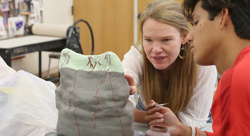 Annie Strader works with a student in 3D art.