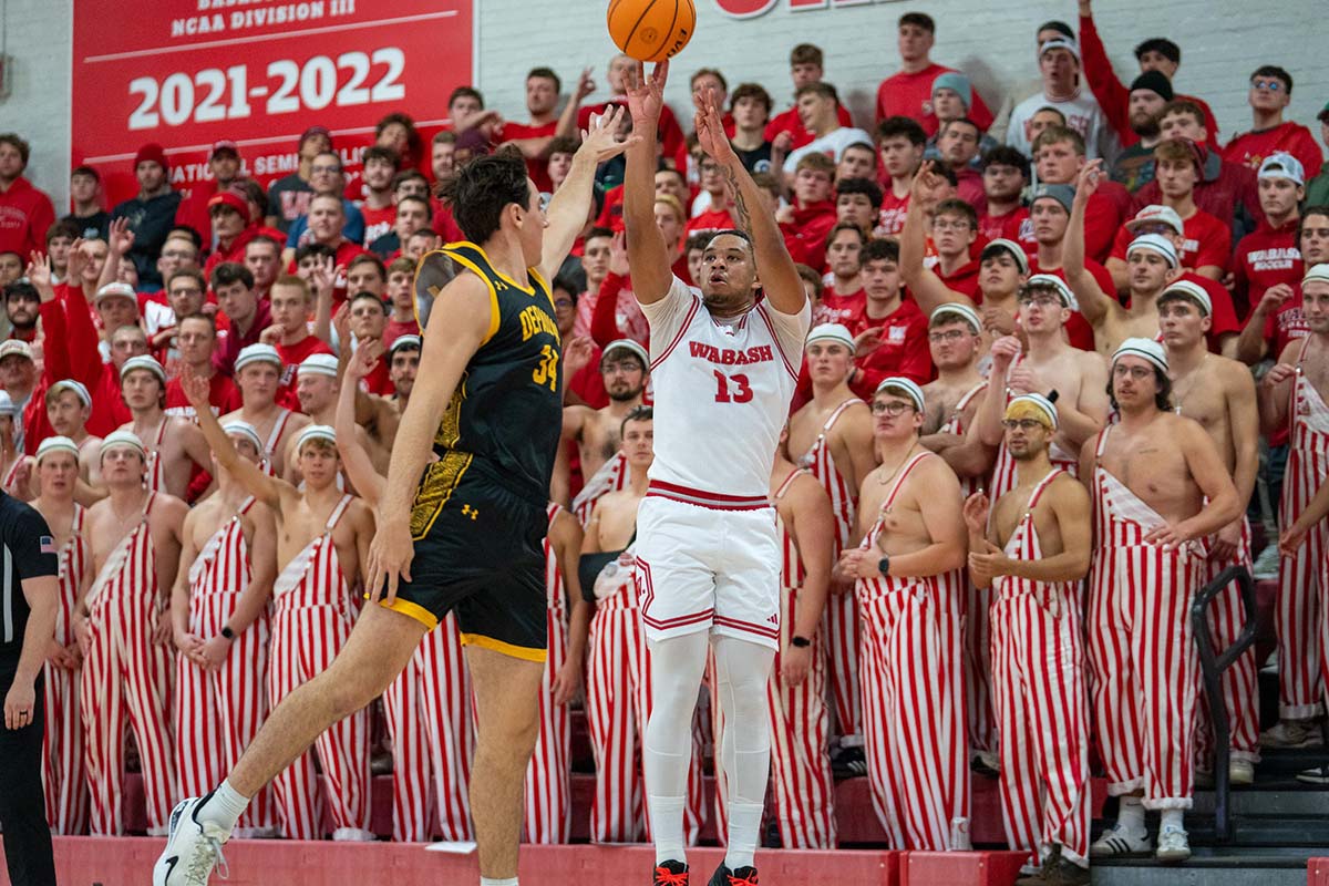 basketball players reaching for a ball