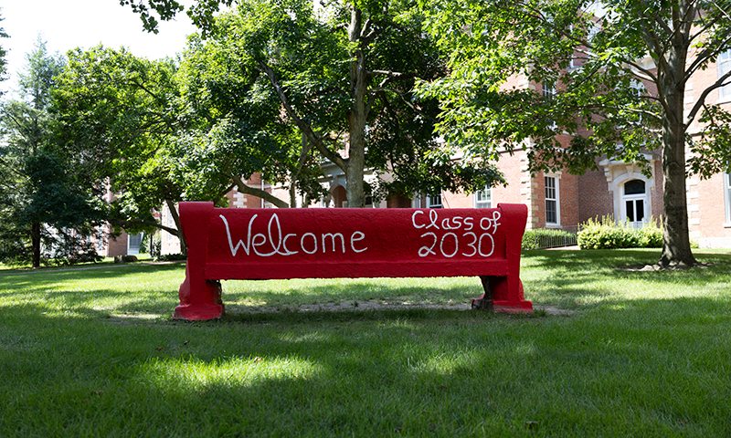 a red bench with white writing on it