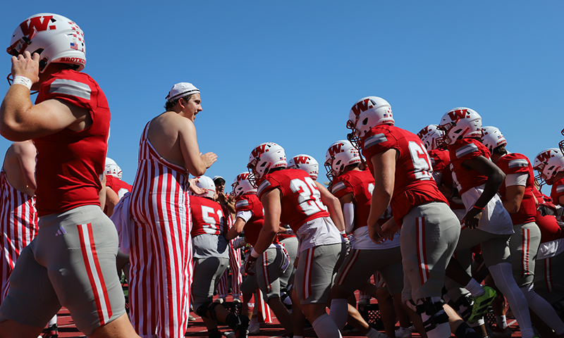 a group of football players in red and white uniforms