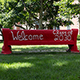 a red bench with white writing on it