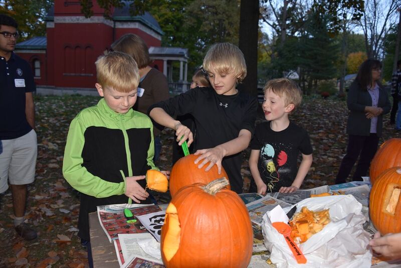 Community Host Family Children carving a pumpkin