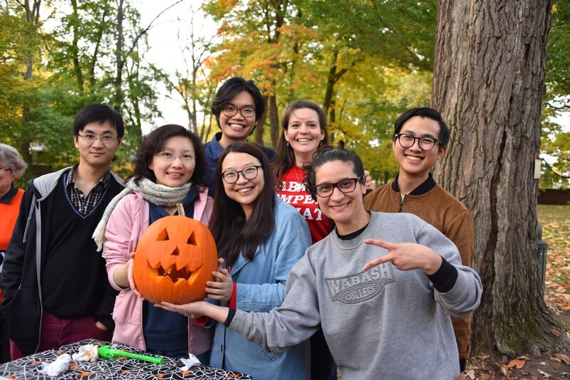 TAs, international students and Amy posing with a jackolantern
