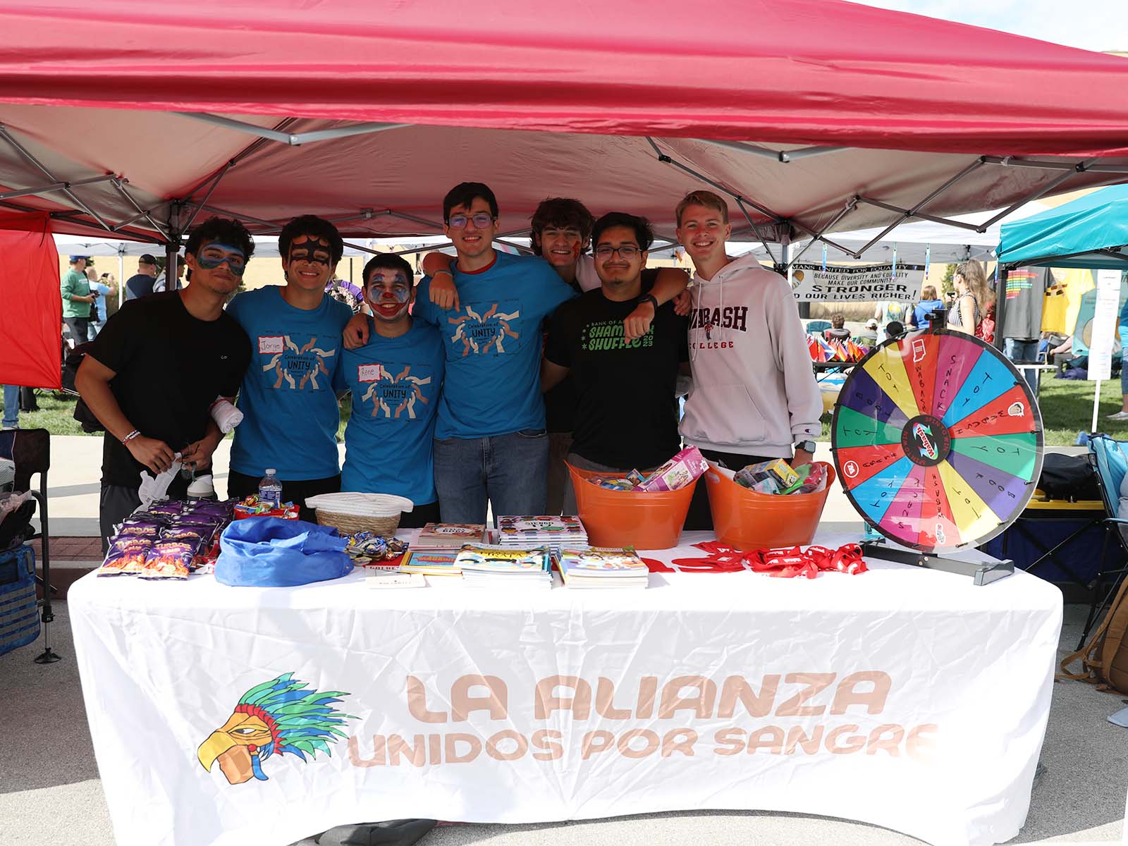 a group of people standing under a tent