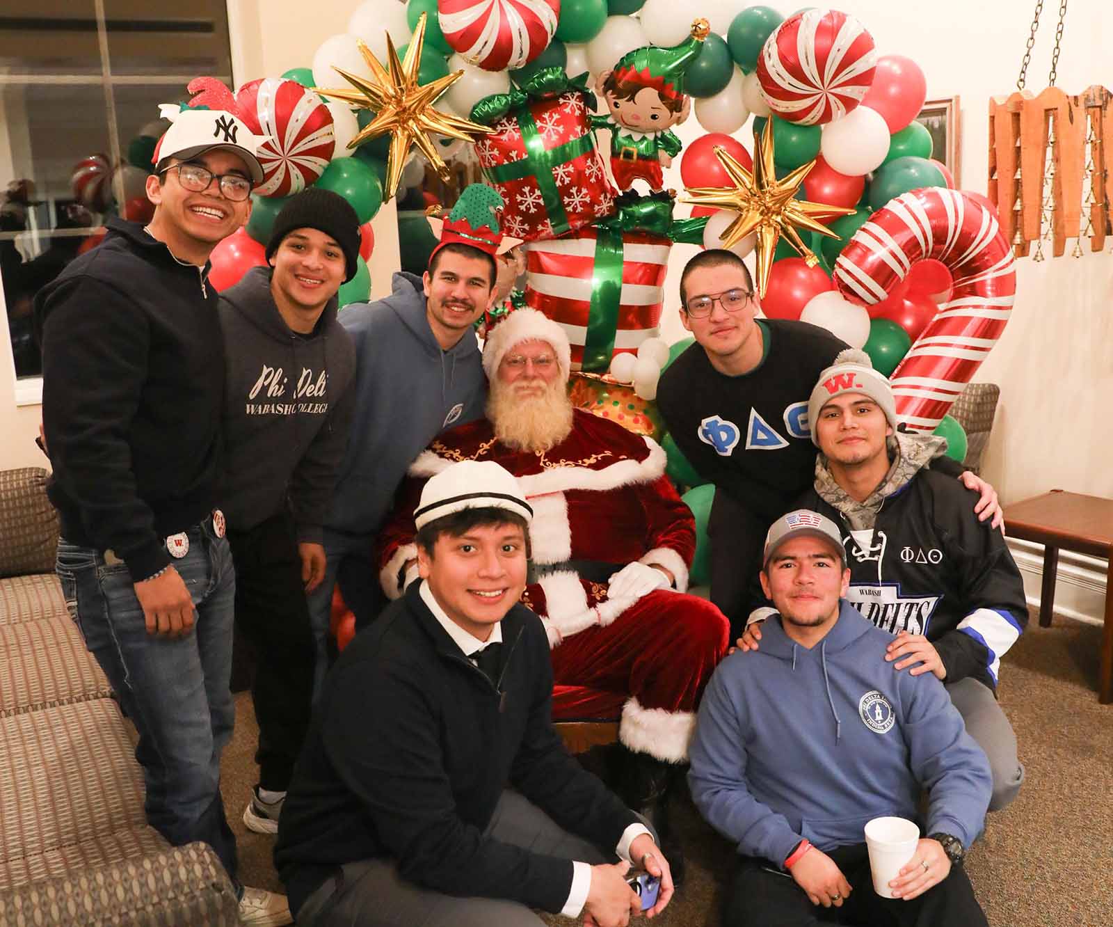 a group of men posing for a picture with santa claus