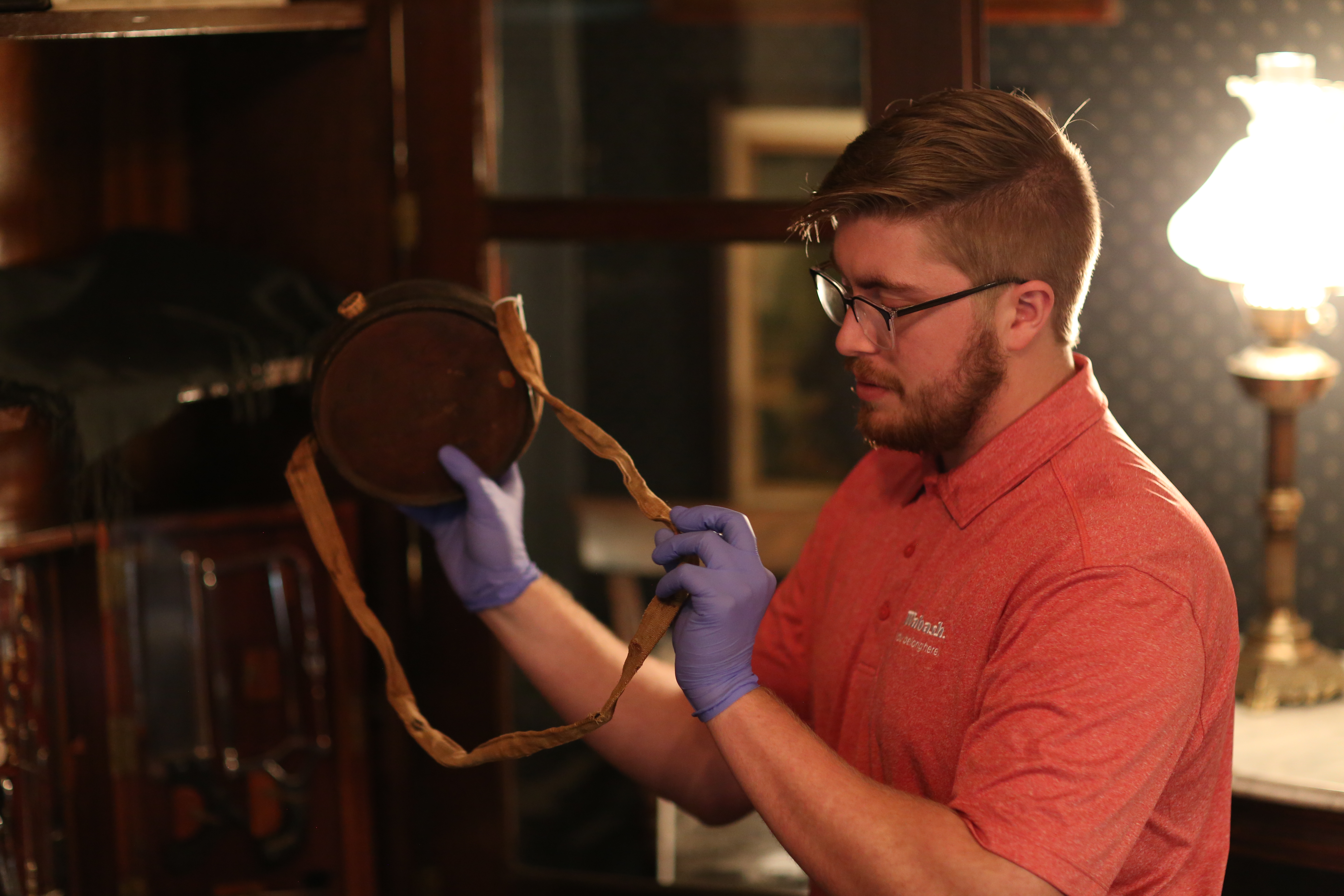 Bennett talks about some of his favorite artifacts inside Lane Place, like this Civil War canteen, during a recent tour. 