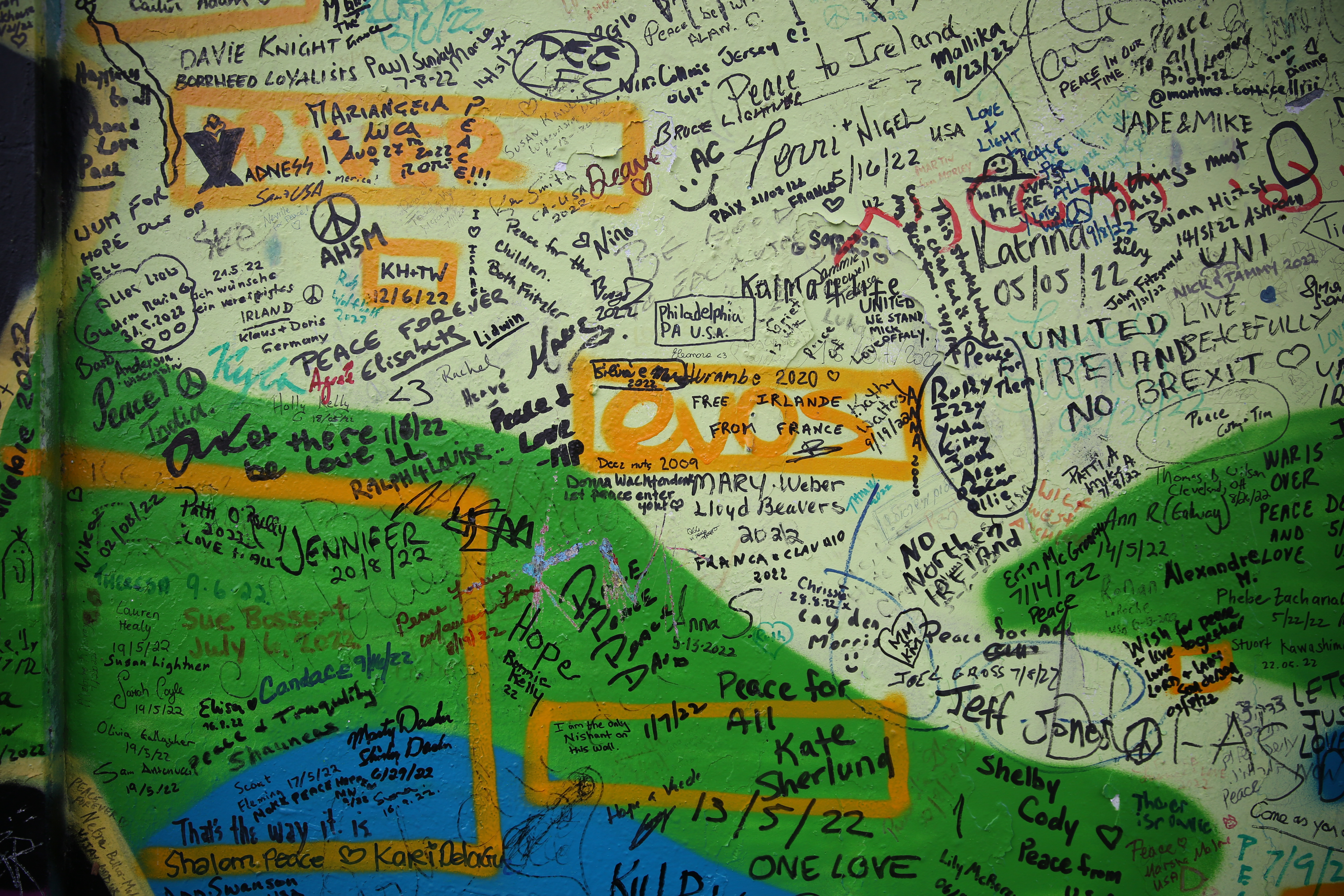 A small section of the Peace Wall on Cupar Way in Belfast, Northern Ireland. The miles-long wall is covered in messages of hope and peace from visitors around the world.