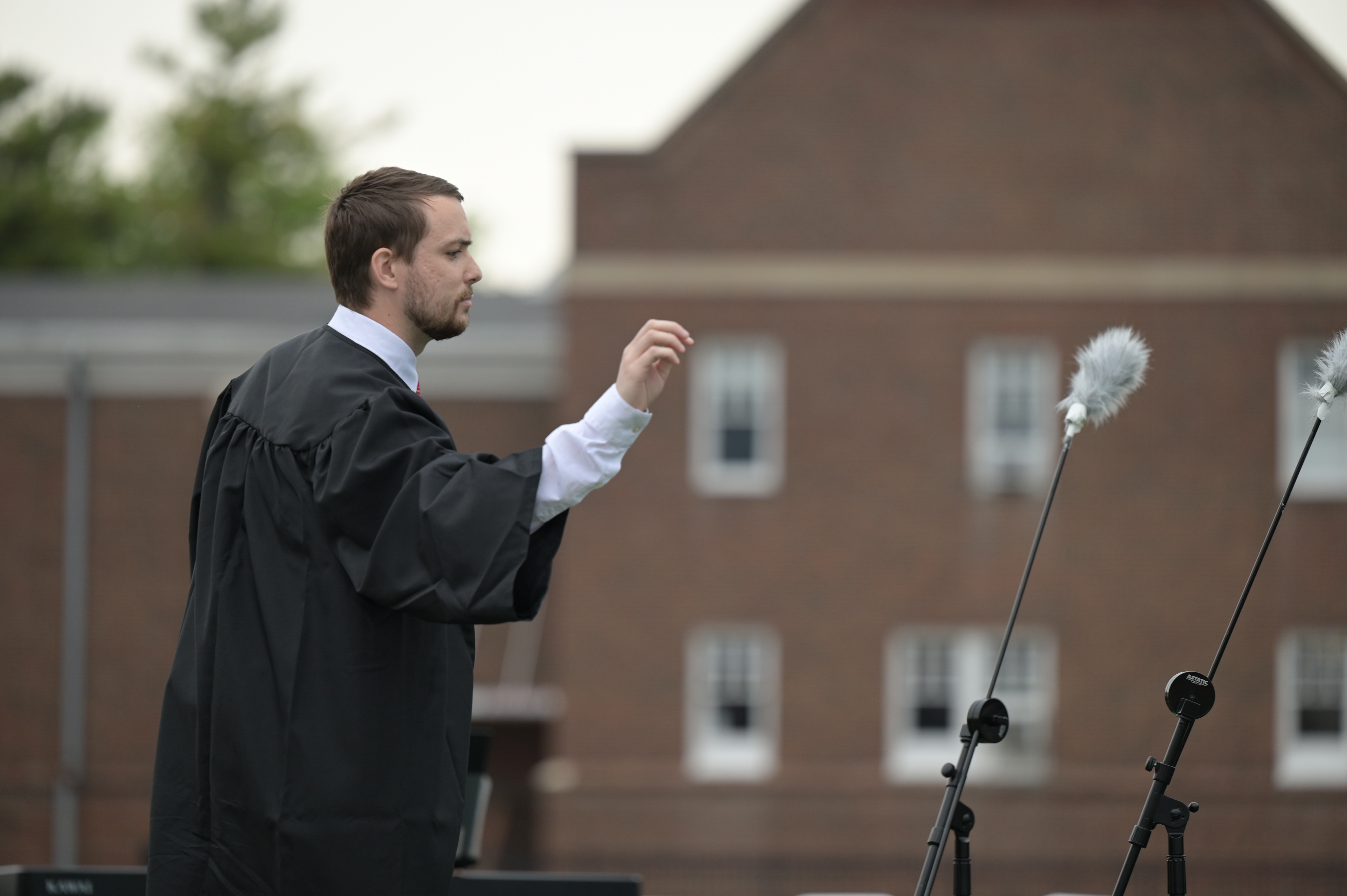 Kuhn conducts the Glee Club in singing the Alma Mater at Commencement.