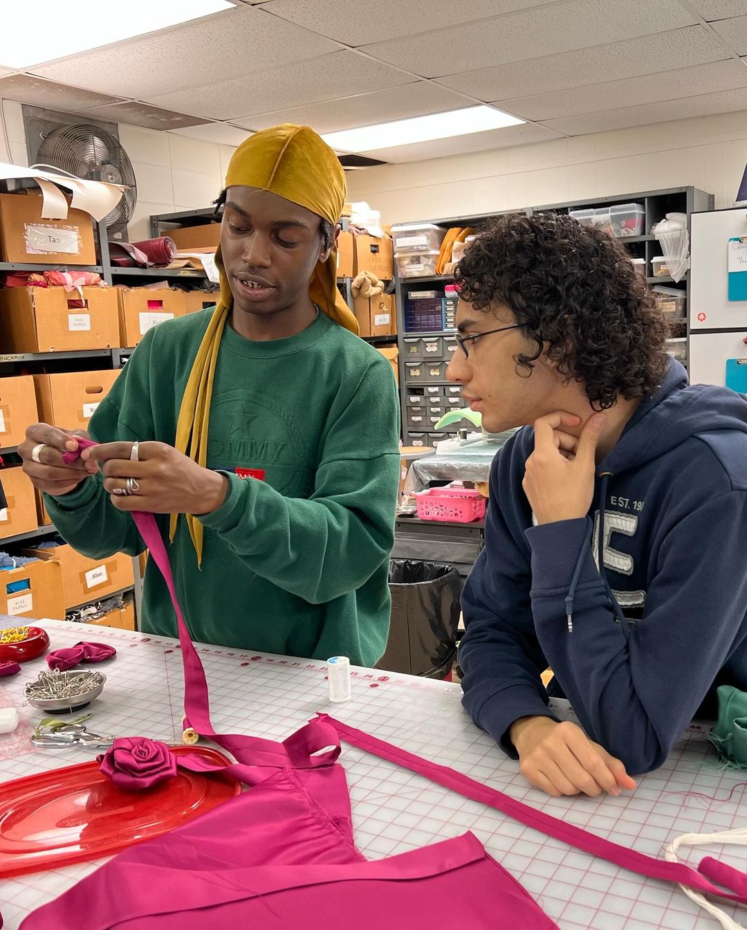 Wilson (left) working with Oscar Jacome Huesca '25 inside the Costume Shop.