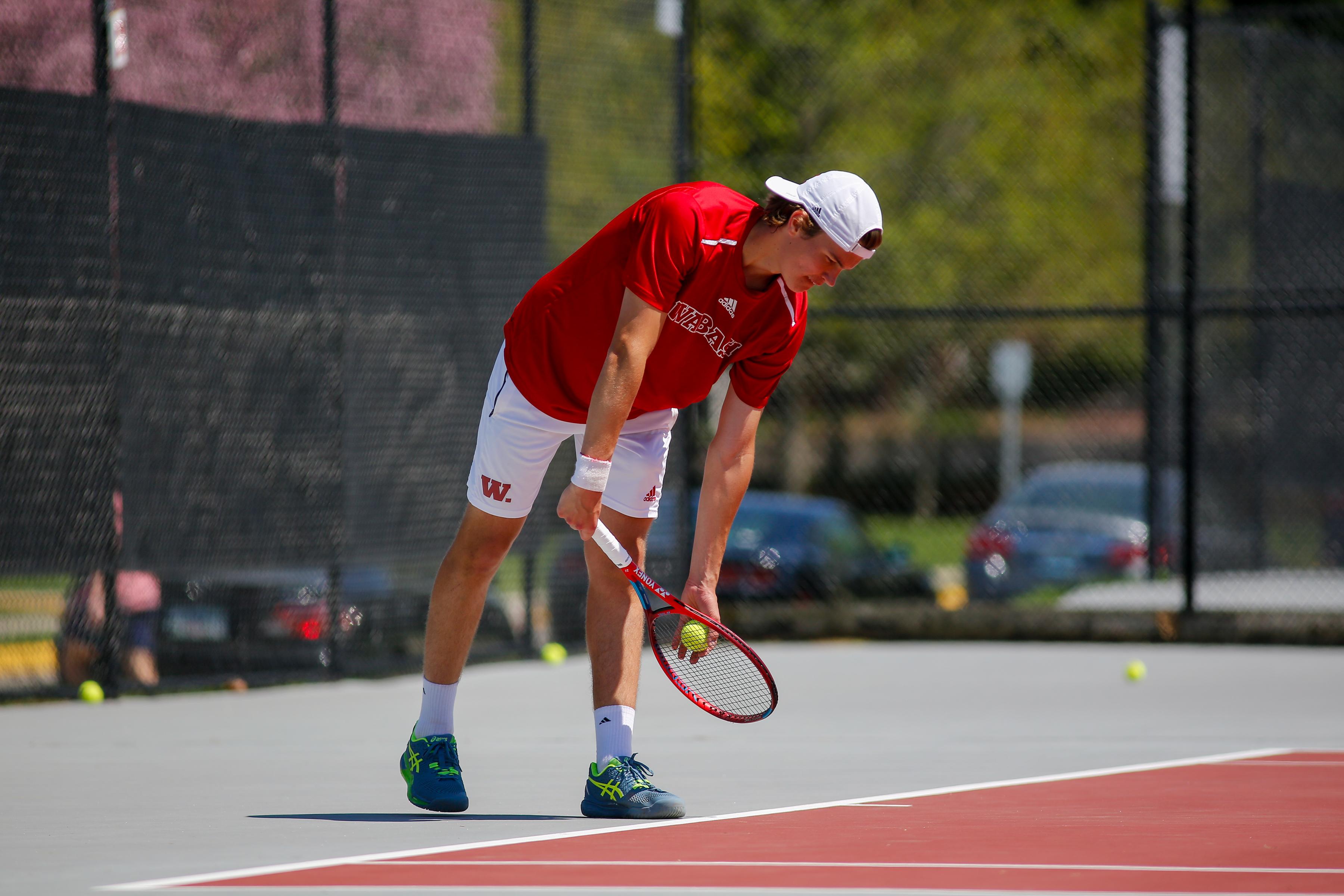 Ghidini winds up to serve at a 2023 match against Denison University.