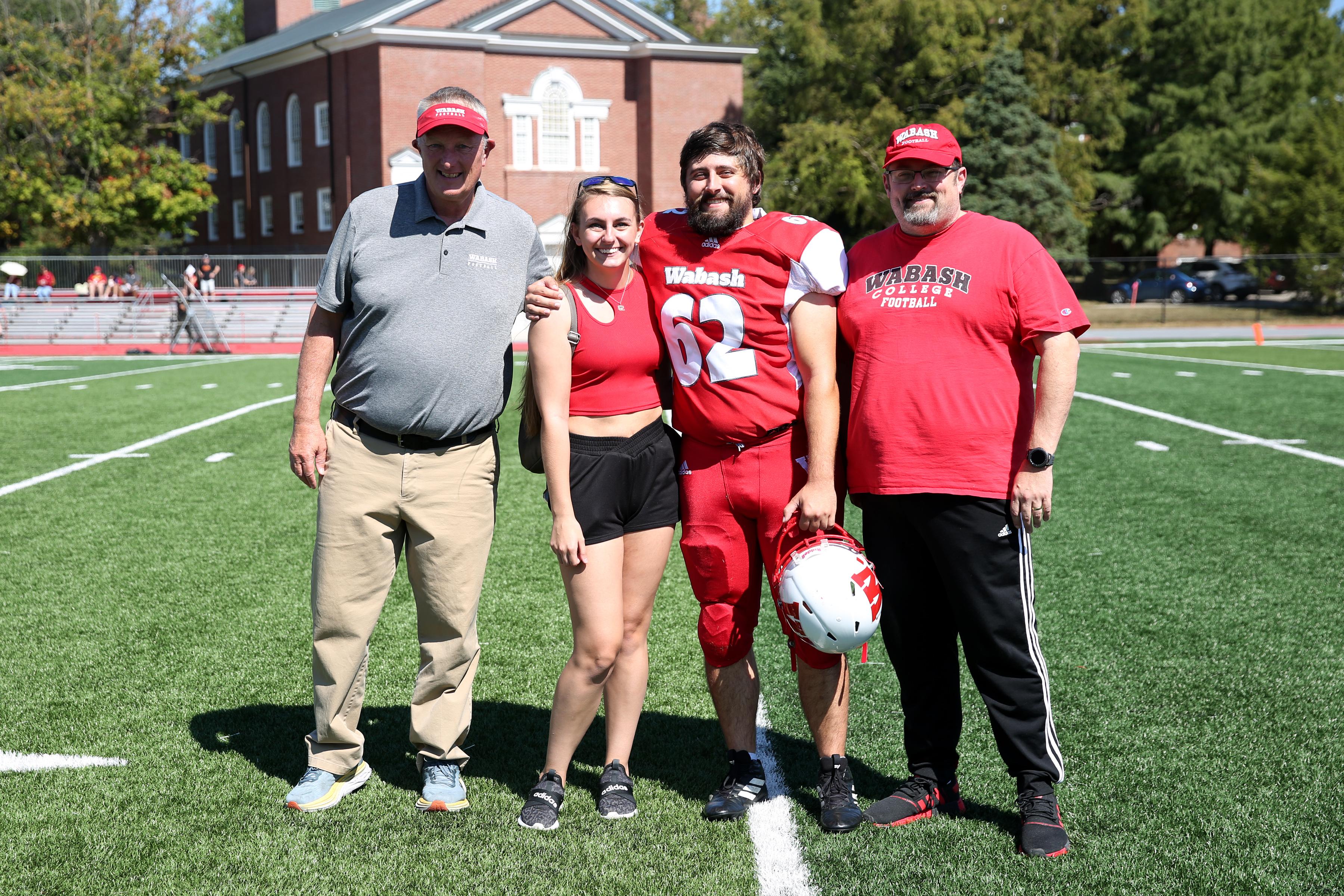Bergman, a Little Giants defensive lineman, celebrates football Senior Day with family and Head Coach Don Morel.