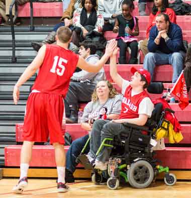 Kasey Oetting shares a high five with Andrew Rusk before a home game against Allegheny.