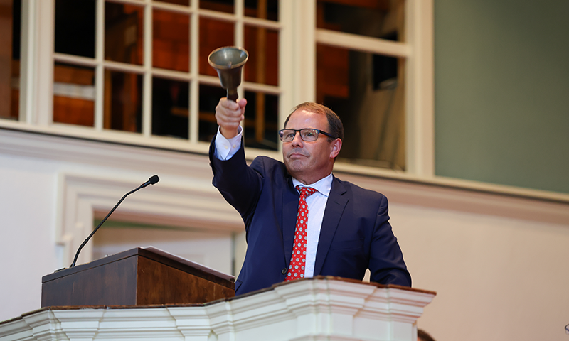 President Scott Feller rings in the new freshman class.