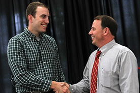 Batchelder (left) receives the Butler Prize from Dean Feller.