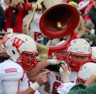 Wabash Football players carry Bell on field after victory.