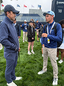 Bledsoe (right) has a conversation during his USGA Pathways Internship experience at Oakmont Country Club during this year's U.S. Open.