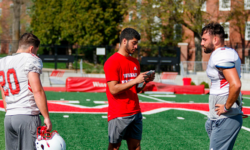 Justin Browder ’26 references his play sheet during practice.