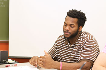 Rhodes takes part in a classroom discussion.