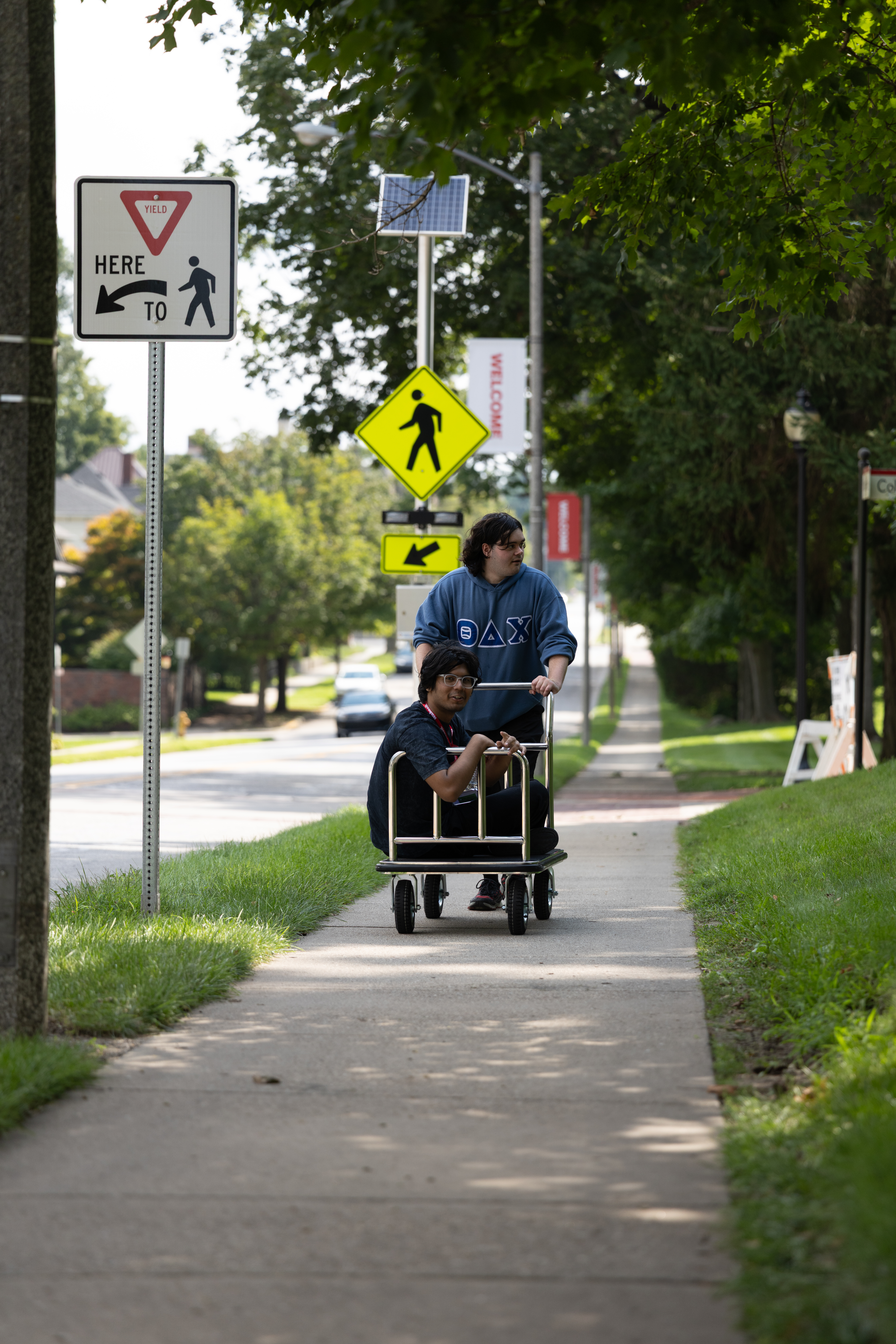 One Little Giant catches a ride on another's cart during move-in.
