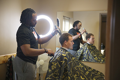 Coleman cuts hair at the MXIBS.