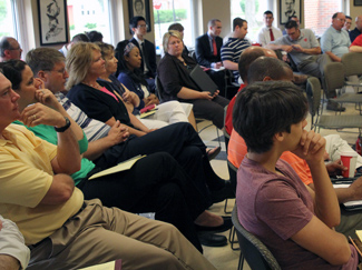 A big crowd of administrators and staff watched the presentation.