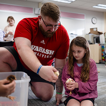 Lewter works with a Nicholson Elementary student