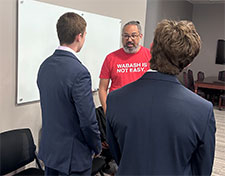Entrepreneur Pat East '00 (center) chats with Wabash students participating in the Business Immersion Program.