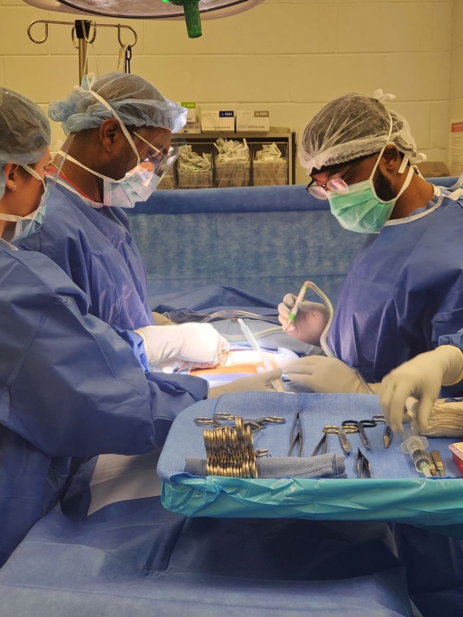 Anthony Douglas (right) works with trauma surgeon Dr. Reuben Rutland.