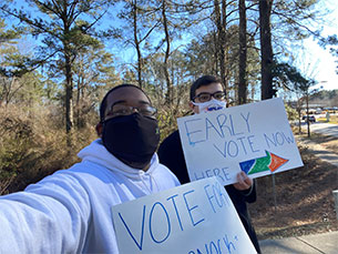 Kevin Griffen '18 (left) and an Amplify Good Trouble co-worker on location in Georgia.