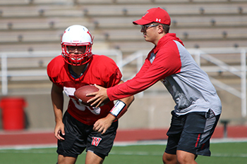 CJ Ramsey '20, right, helps run a drill during practice.