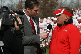 Sideline reporter Matt Hudson ’09 interviews Coach Erik Raeburn in the 2011 Bell Game.