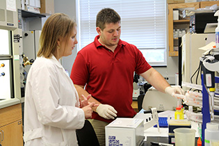 Biology professor Heidi Walsh with Zack Campbell '18.
