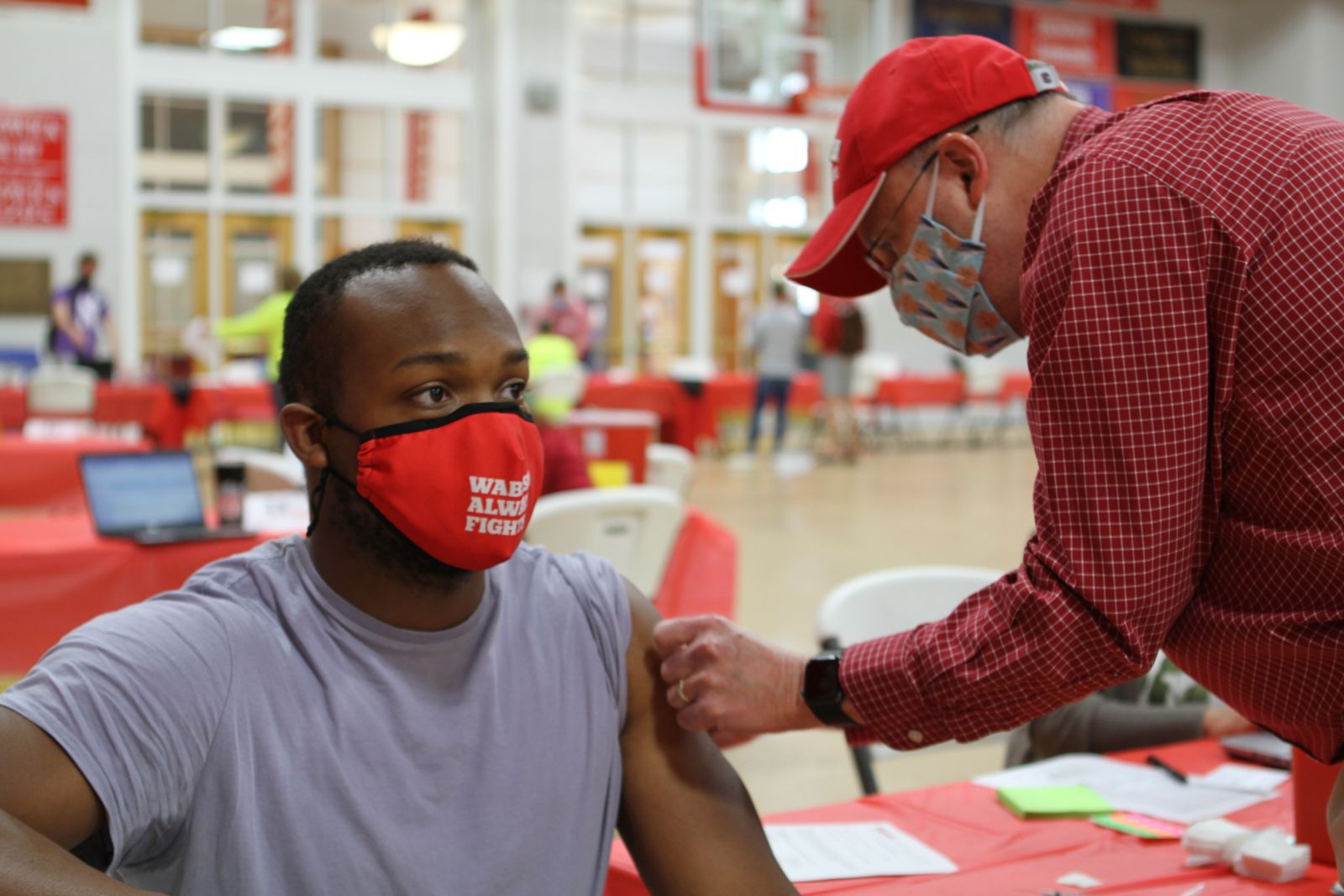 Malcolm Lang ’21 receives his first Pfizer shot on April 9 at the #BashCOVID vaccination clinic.