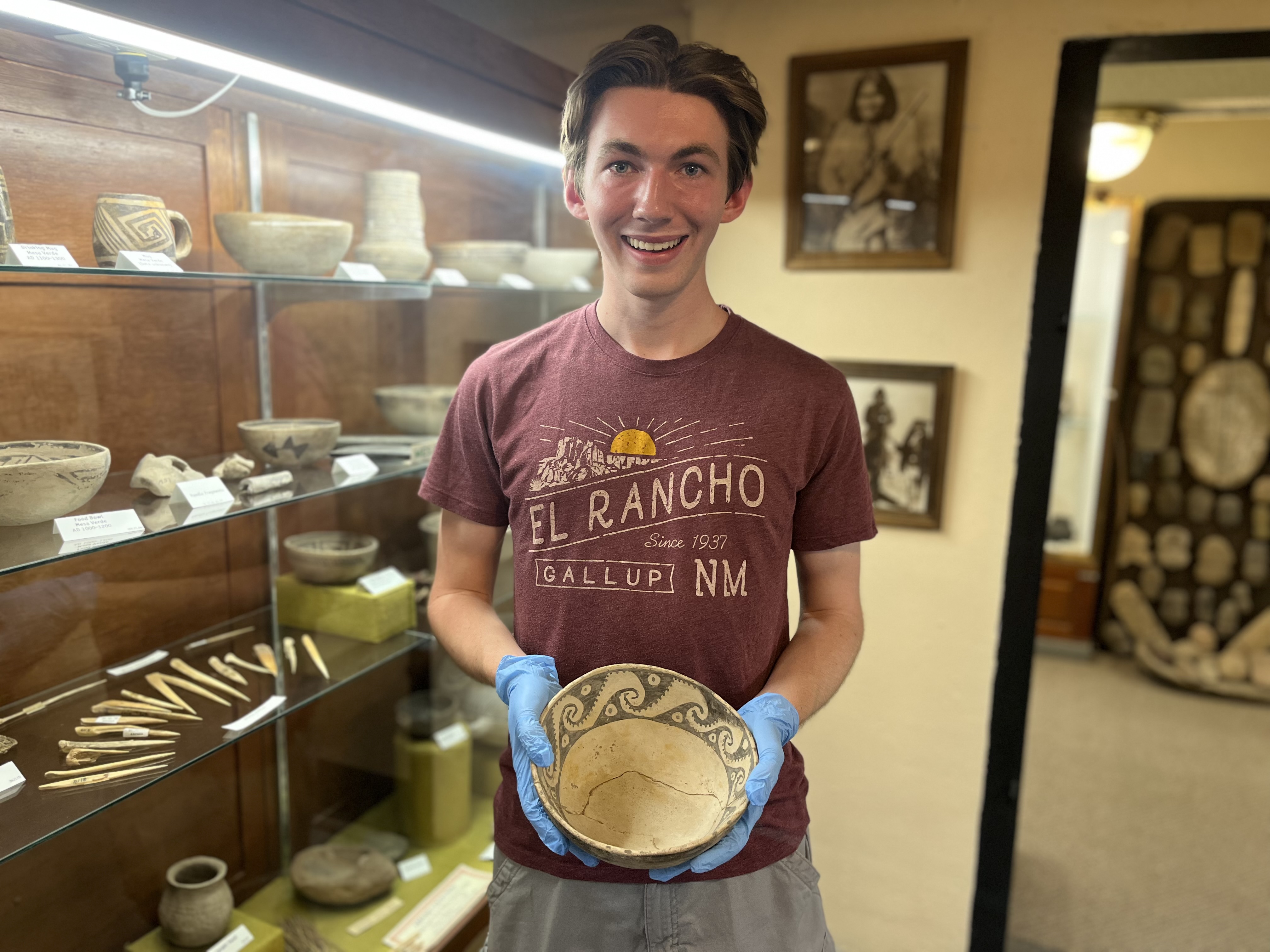 Monninger holds an Ancestral Puebloan food bowl. It is part of the Abrahms Collection of relics found at Aztec Ruins before 1916. 
