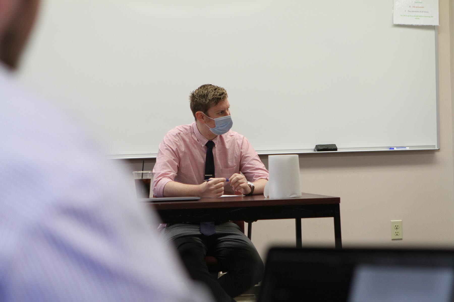 Visiting Instructor of Rhetoric James Proszek listens closely to the engaging conversation. 