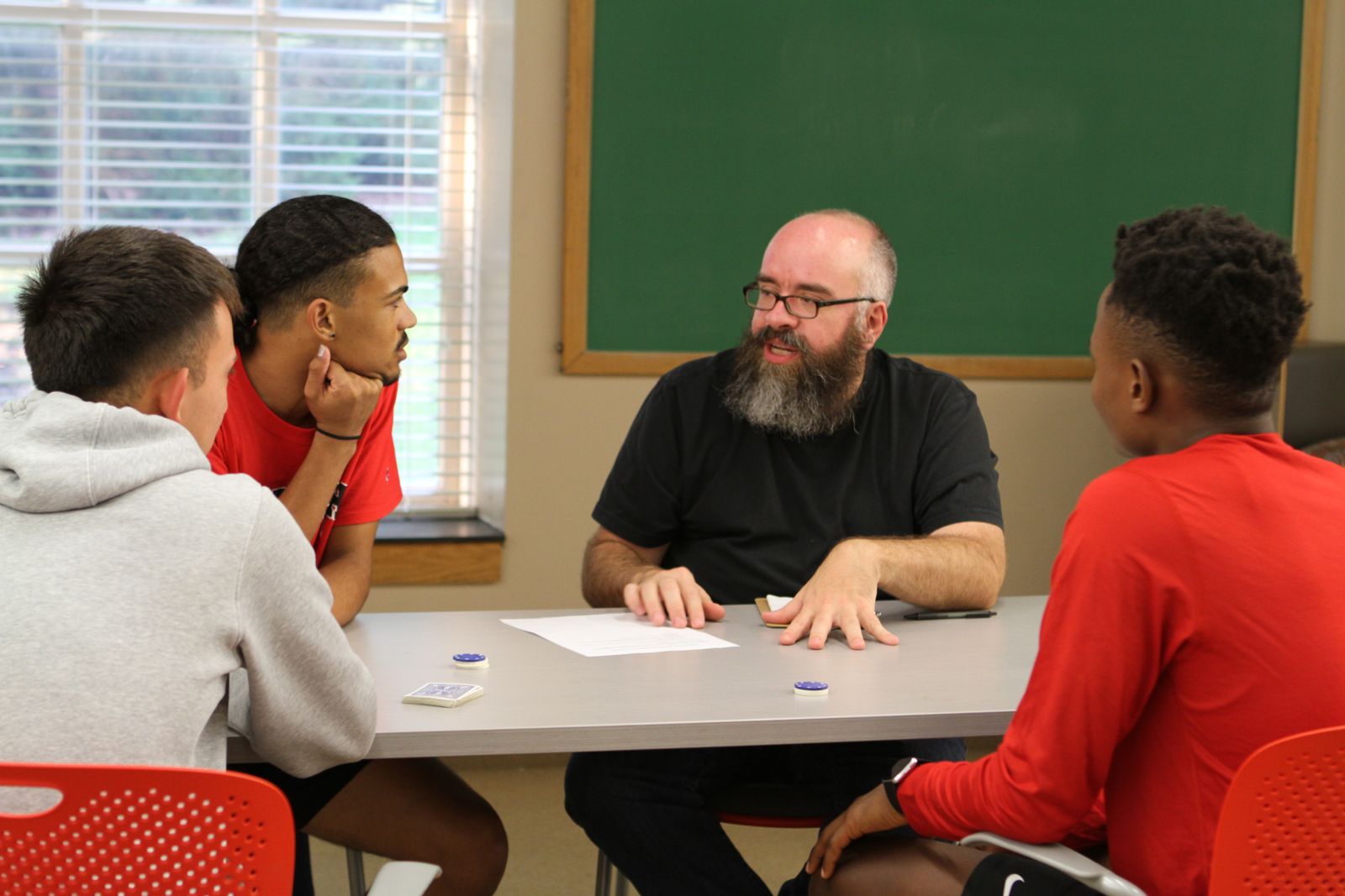 Art Professor Matt Weedman talks with WLAIP students about their game design project.