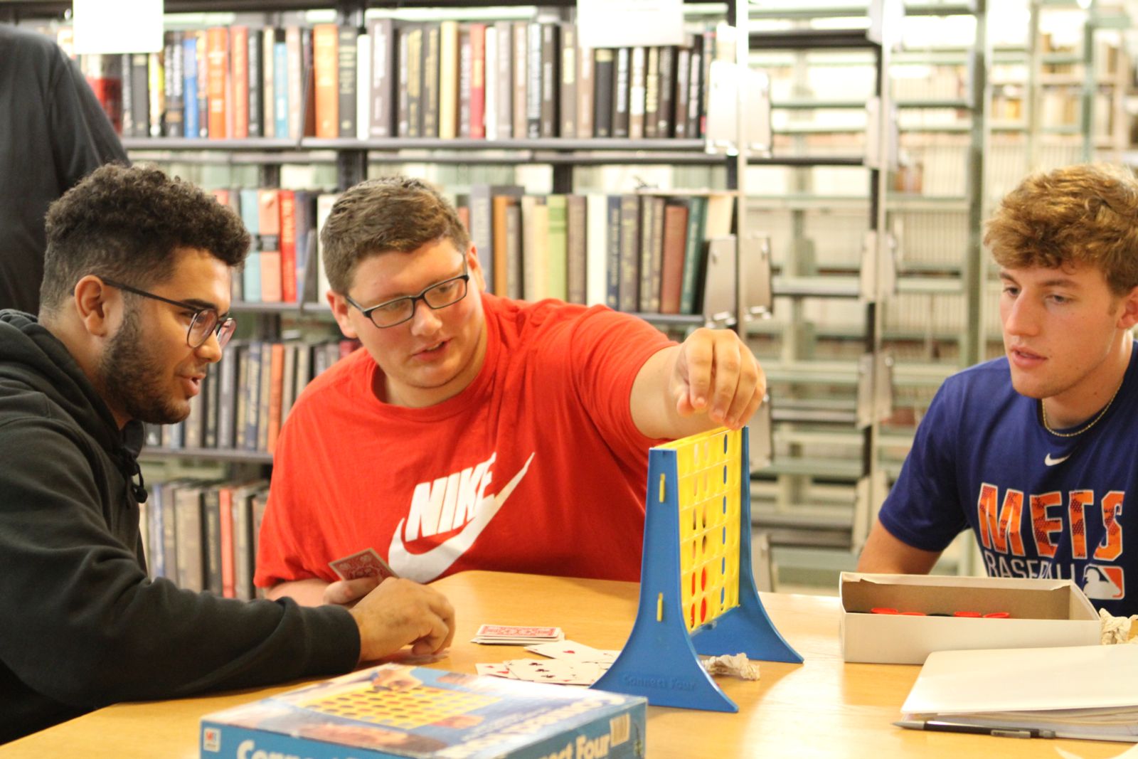 Students play test their game, which incorporated cards and "Connect 4."