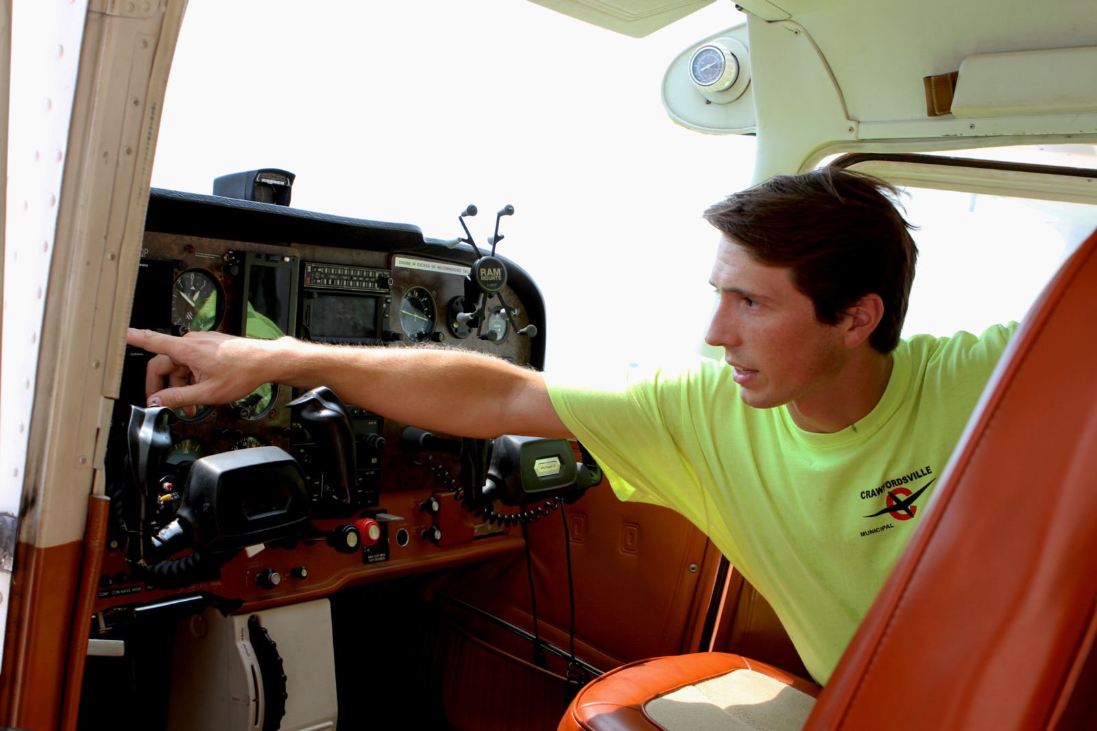 Ethan Pine '22 examines the controls and indicators inside an airplane.
