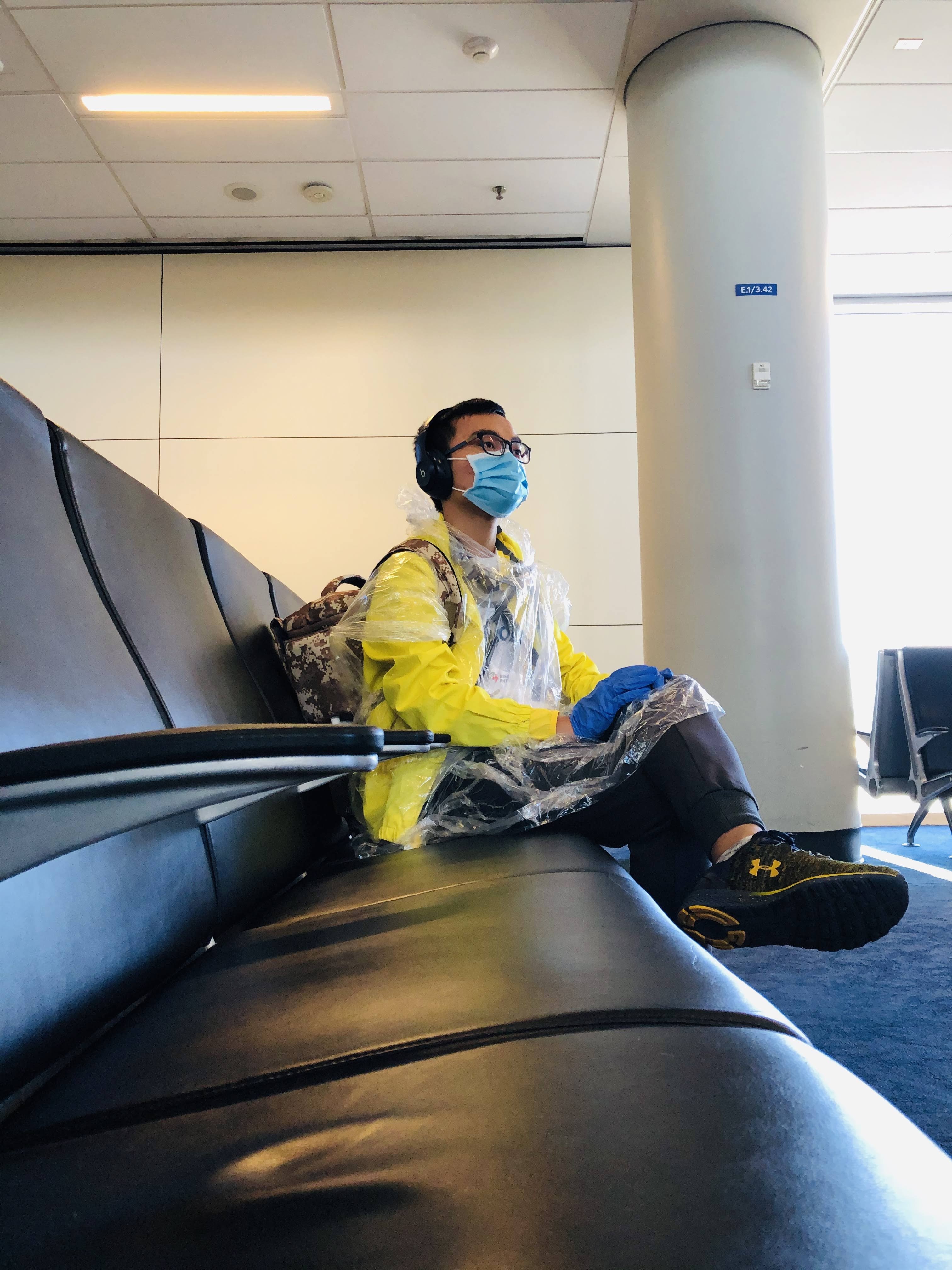 Truong masked in personal protective equipment while traveling home during COVID-19.