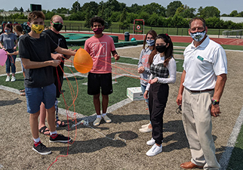 Gilbert leads a team building activity.