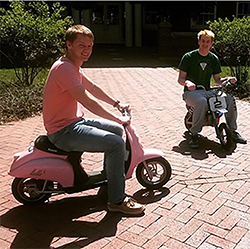 Hunter, left, riding mopeds on campus with Whitaker
