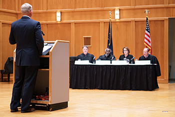 Lange, left, in front of the panel of judges