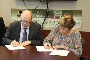 President Hess (left) and the MCHD's Nancy Sennet make the partnership official.