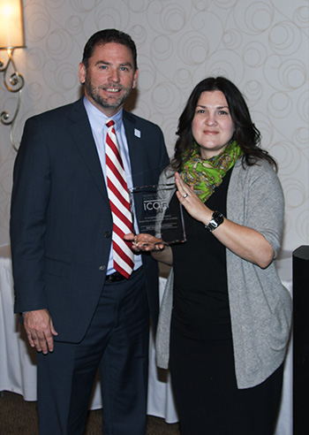 Michael Raters accepts the Dean McKaig Award from Lisa Hutcheson, ICAN Director.