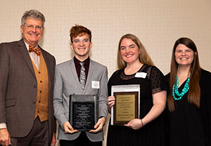 McKinney (second from left) receives his award.