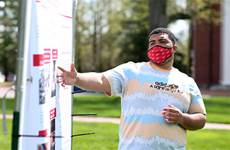 Isaiah McWilliams ’22 gives a poster presentation at the April 16 Celebration of Student Research, Scholarship and Creative Work at Wabash College. The poster presentation portion of this event, now in its 21st year, was held outdoors on the Mall due to COVID-19 restrictions.